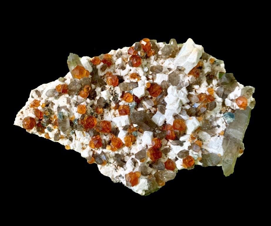 Garnet var. Spessartine, Smoky Quartz, Feldspar, minor Apatite